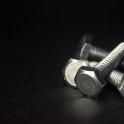a couple of screws sitting on top of a table
